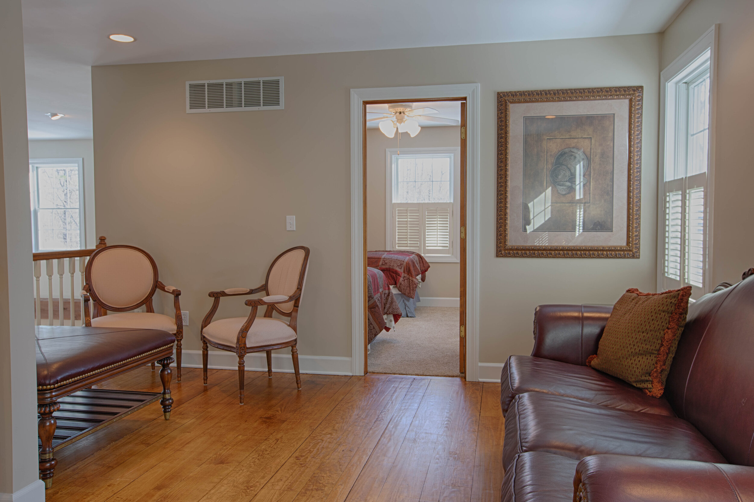  Off the bedroom is a sitting room with a leather couch 