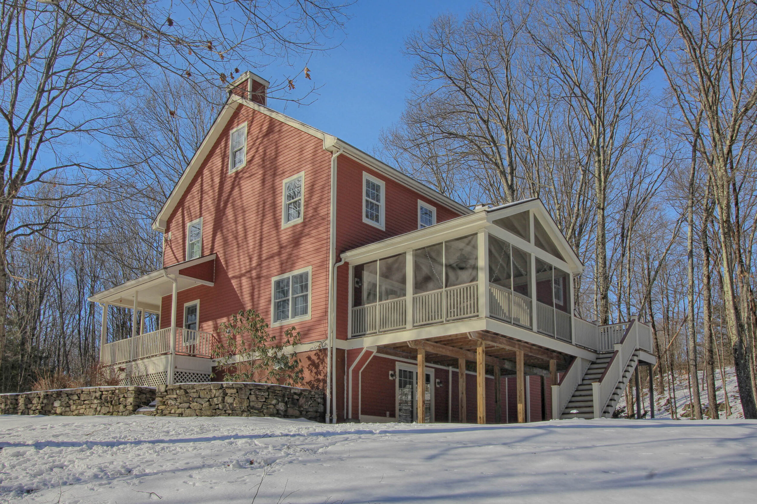  Outside of home with a side angle.  This shows the back, elevated screened in porch and a portion o the front covered porch.   