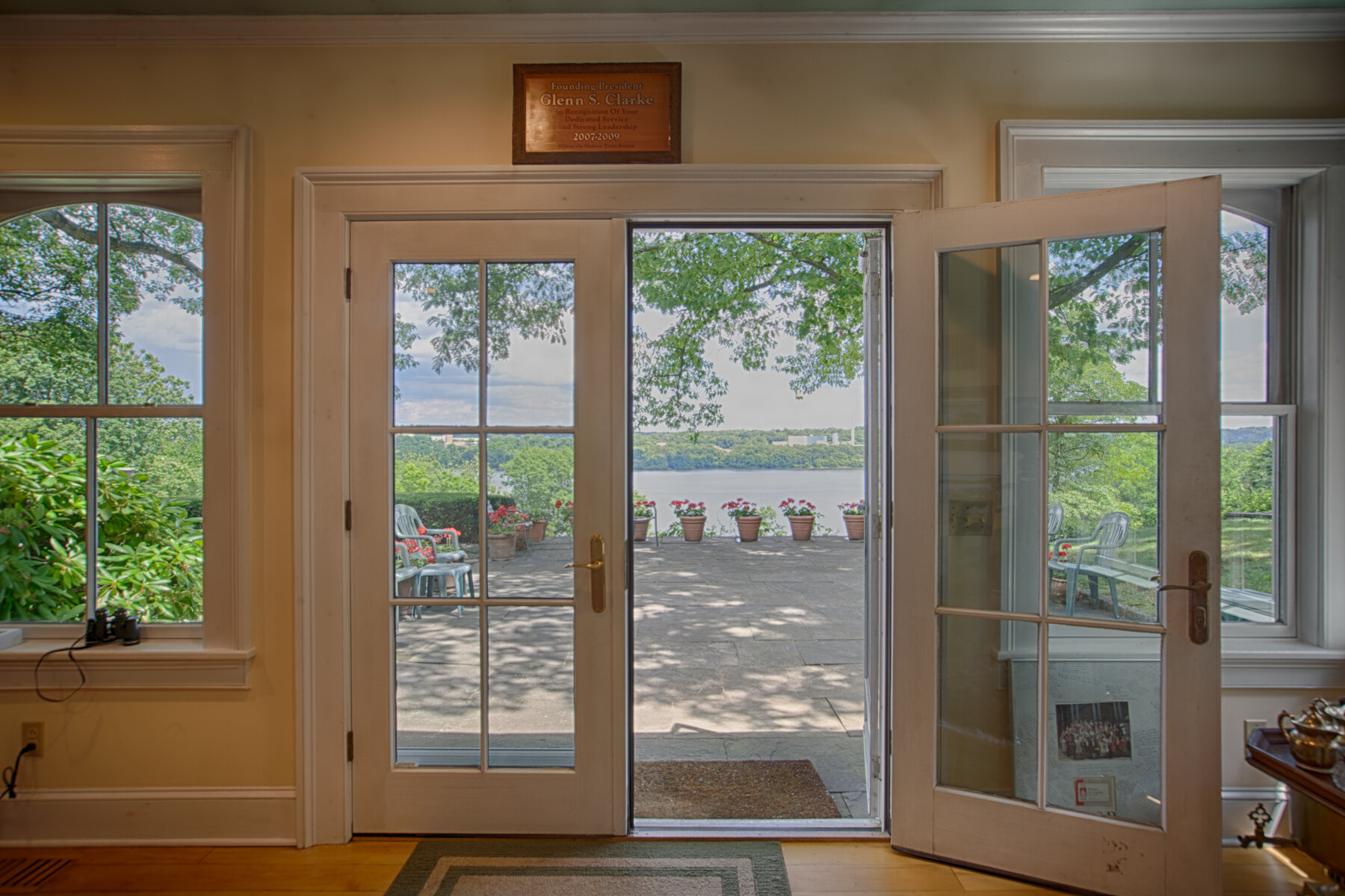  French doors opened to show the view of the over sized patio and a glimpse of the water. 