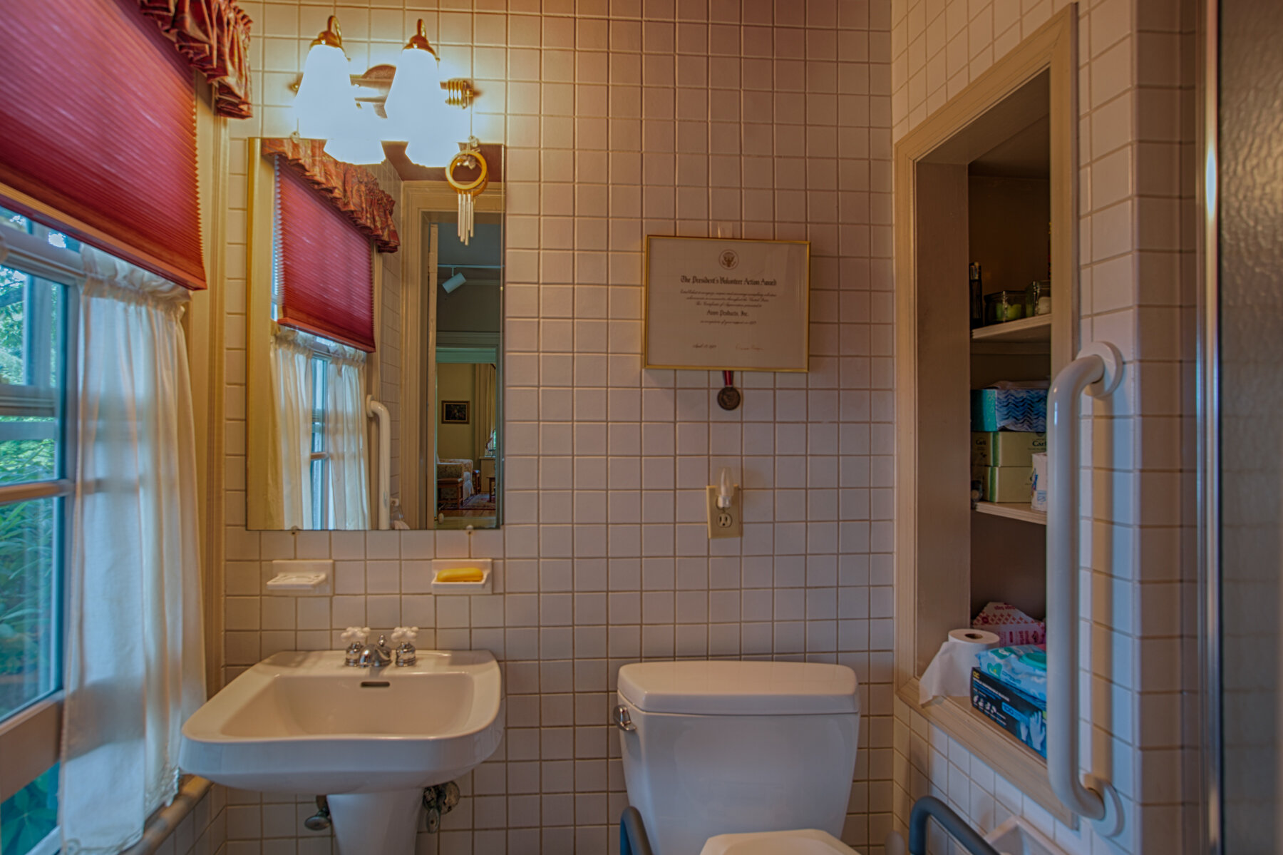  Smaller bathroom with toilet, pedestal sink and stand up shower. 