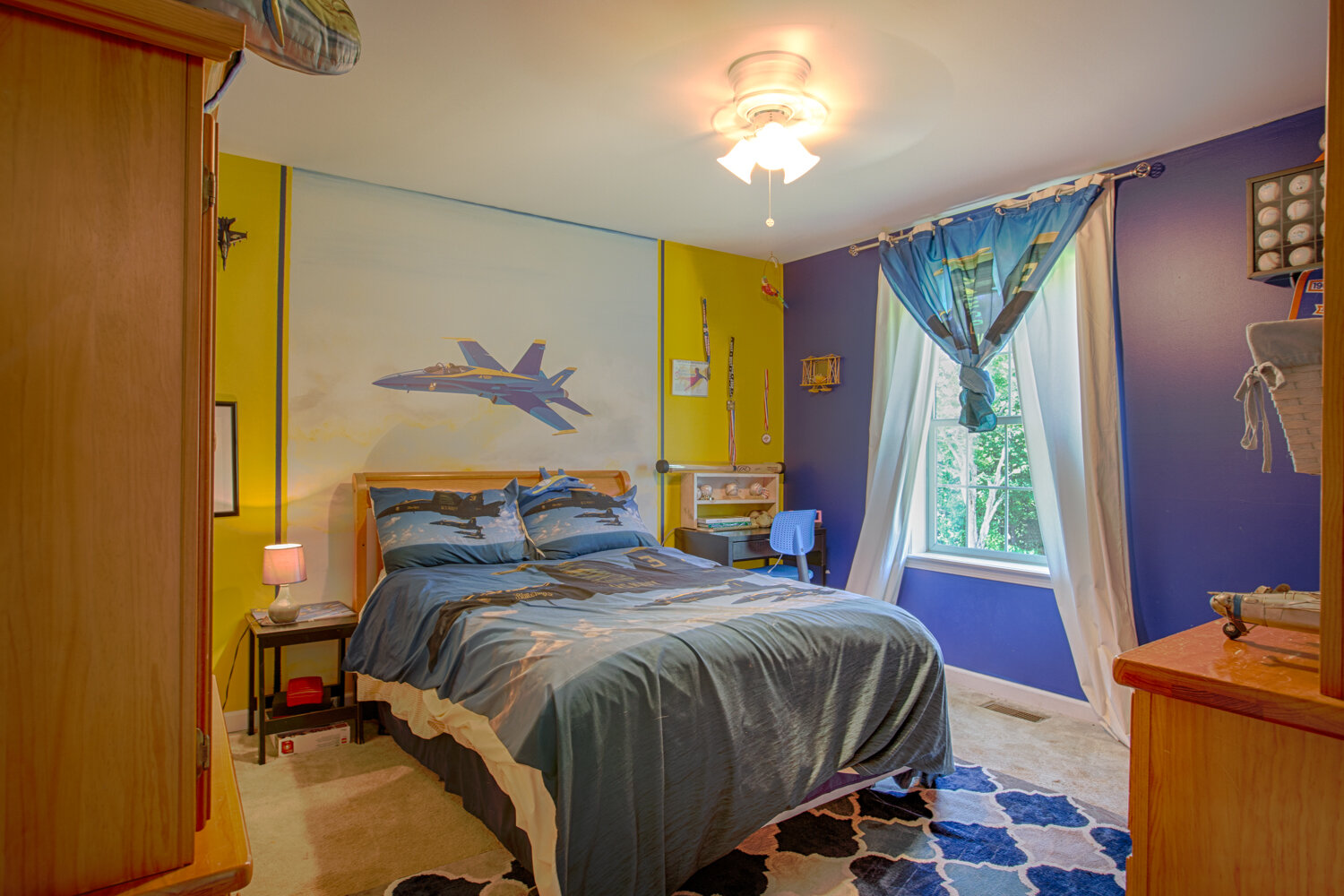 bedroom with periwinkle walls and accented flooring