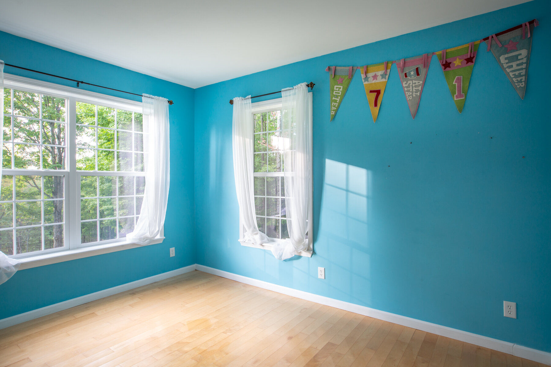 powder blue painted walls bedroom with wide windows