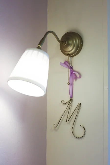 gold sconces with lavender walls girls room.jpg