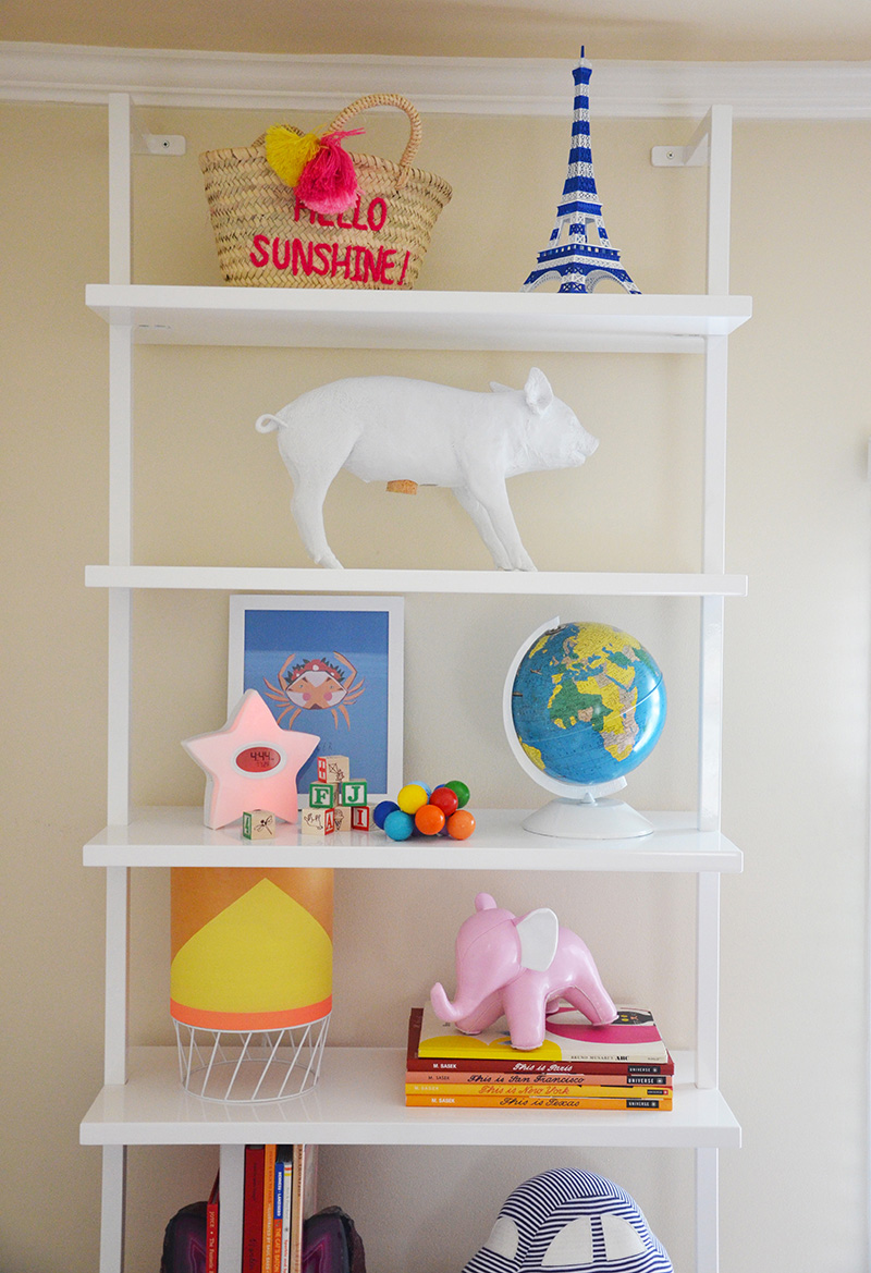 Wall hugging shelves offer a place for June to store vintage books, a modern lamp found by her parents on a weekend in Palm Springs, a piggy bank by artist Harry Allen found at Erin Martin's Napa showroom, a vintage globe lovingly restored by June's dad and other meaningful gifts and finds.