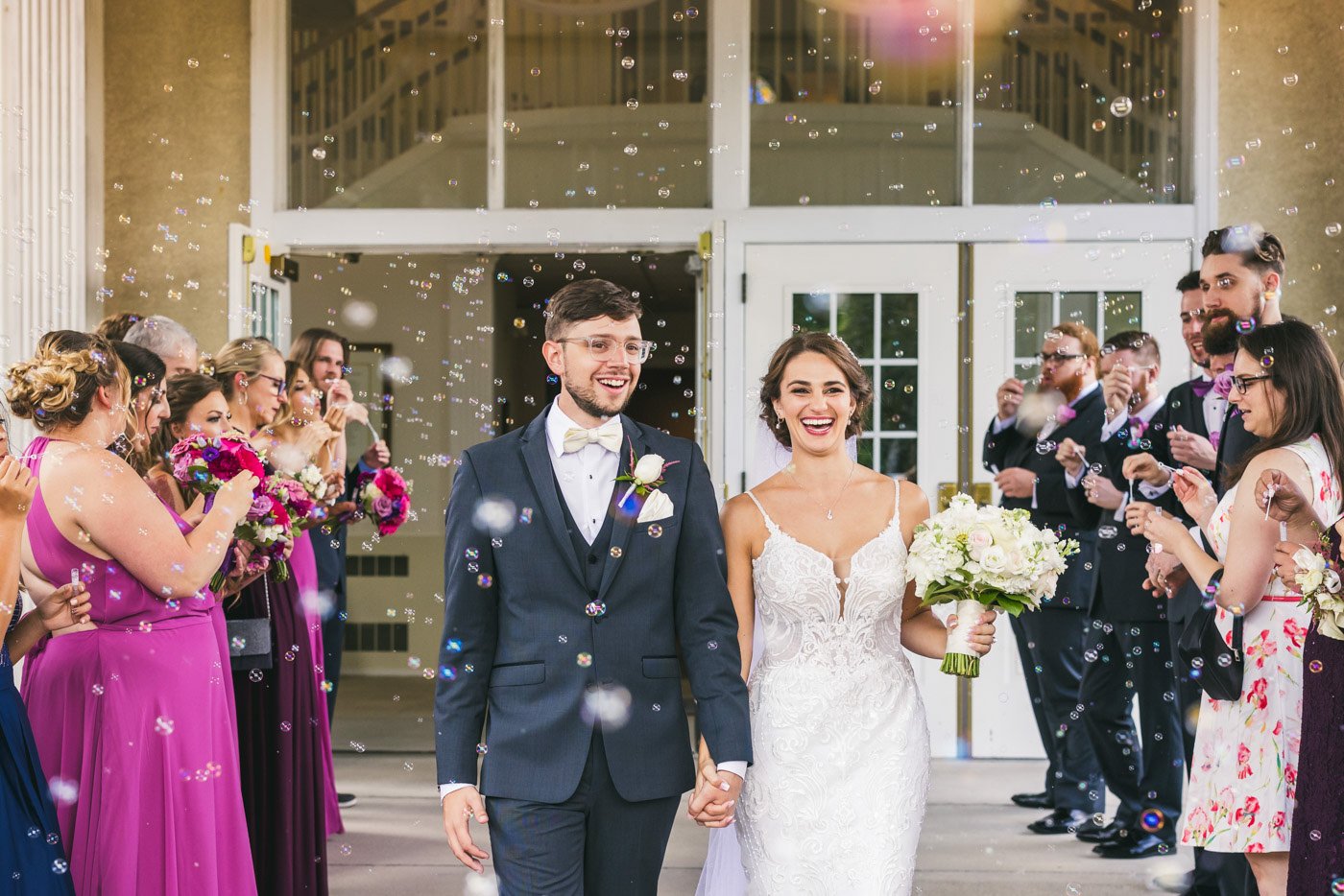 bride and groom walk between guests during bubble exit