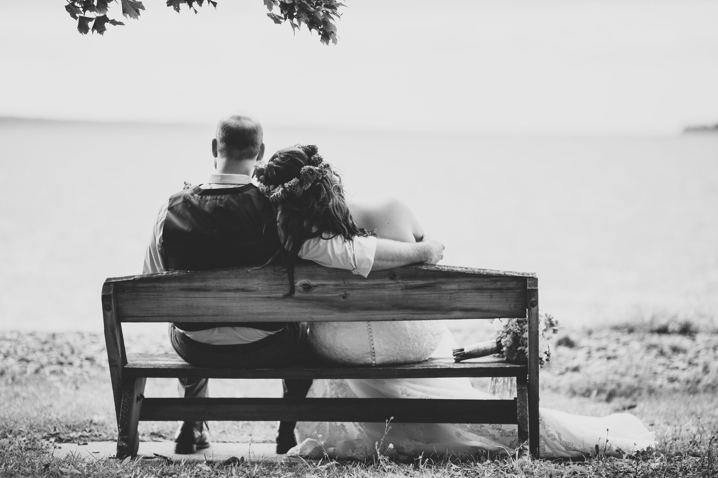 bride-groom-sitting-on-bench-lakeside-tr