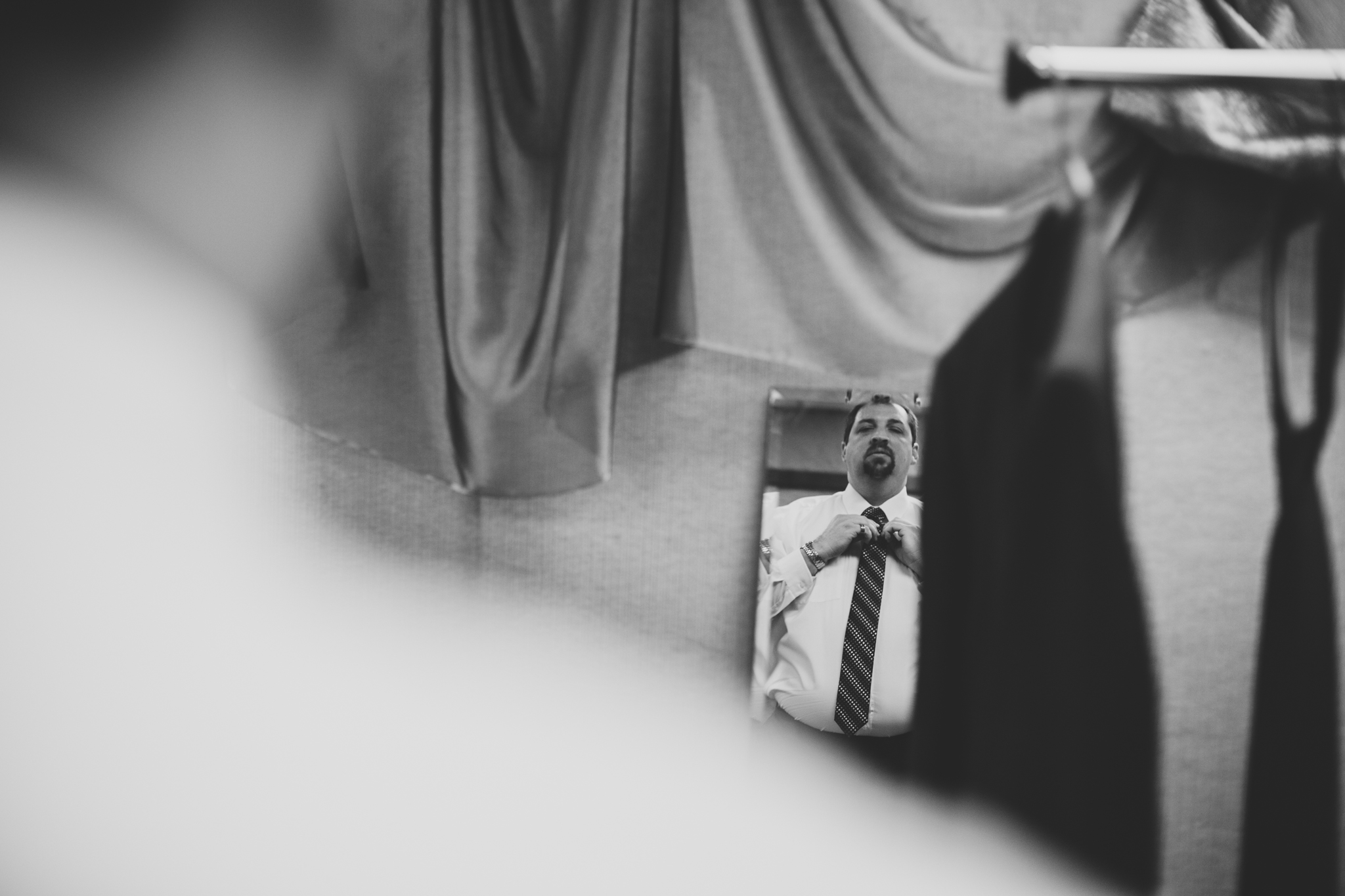 rs oklahoma city wedding groom looks in mirror black white