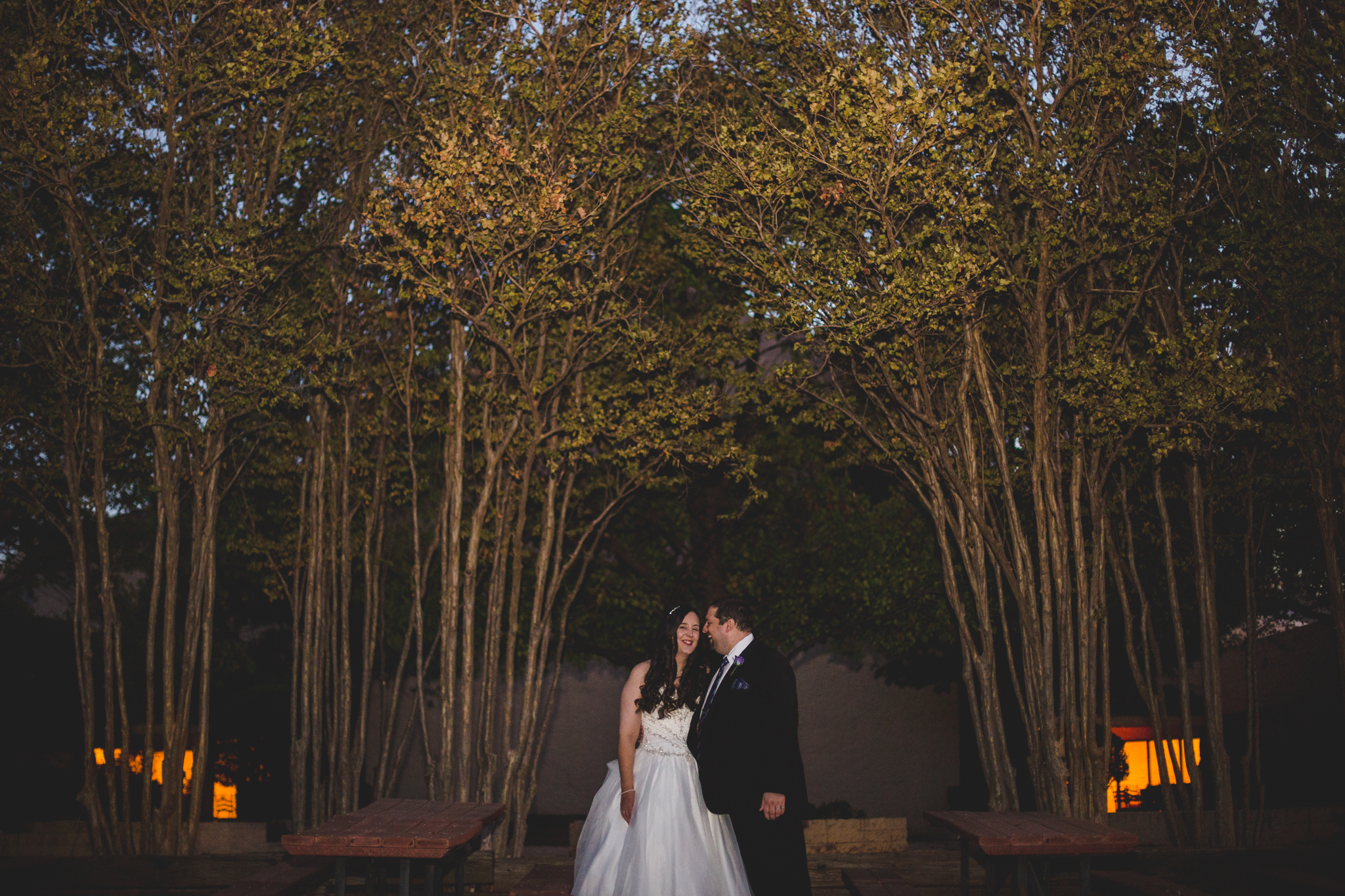 rs creative bride and groom laugh among trees at night cool