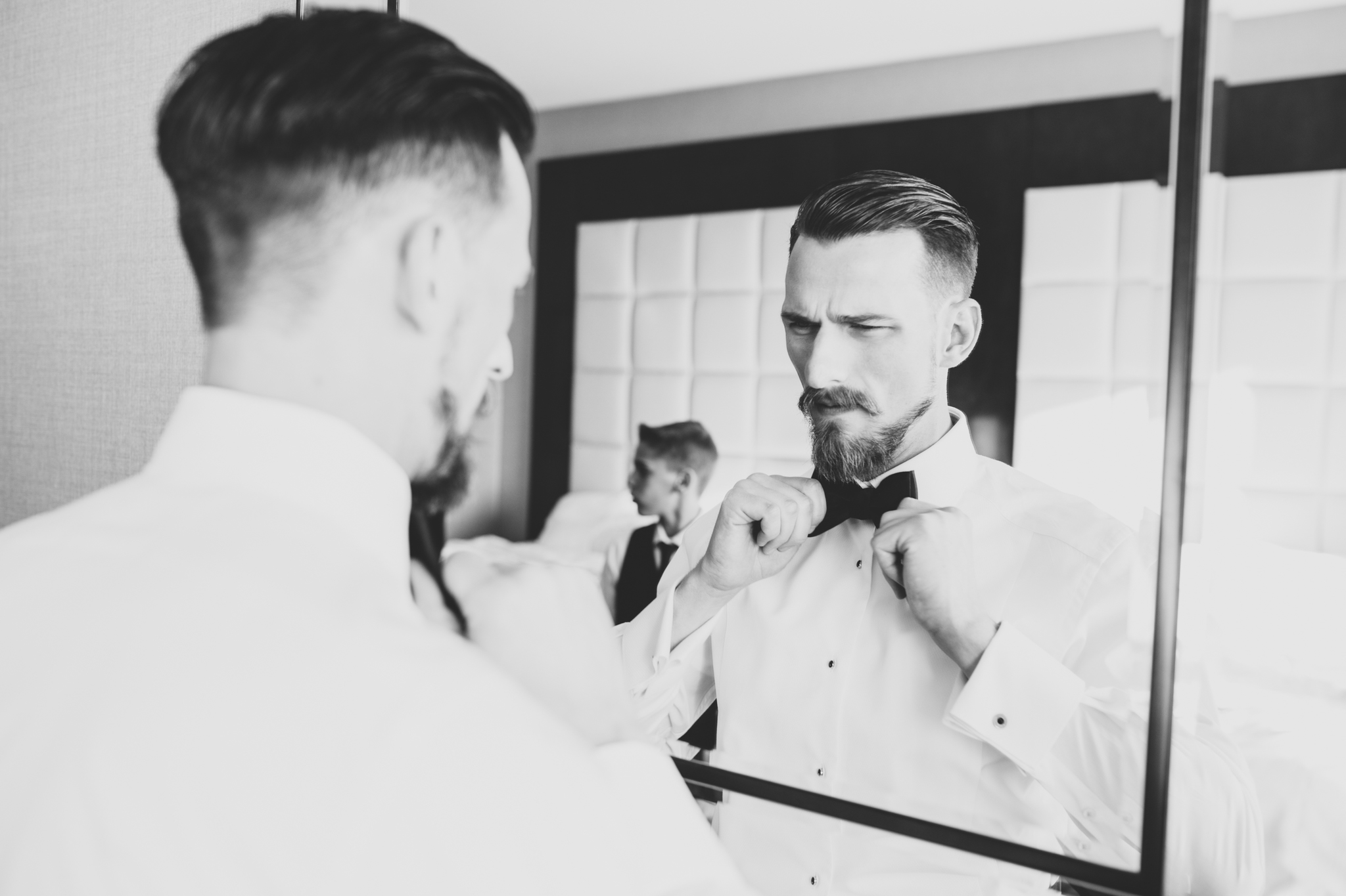groom finishes his bow tie black and white hj