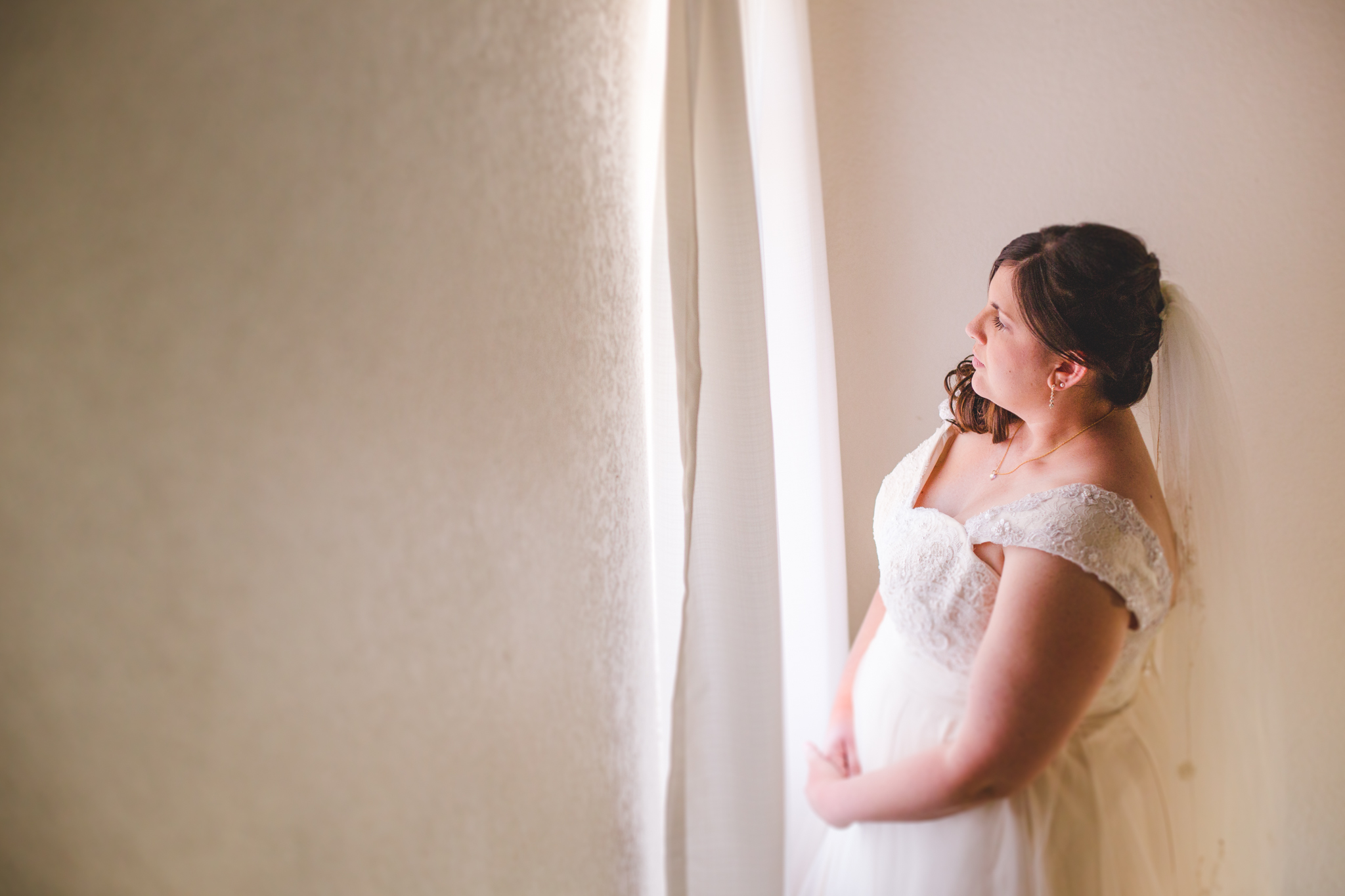 bride looking out window of house sd