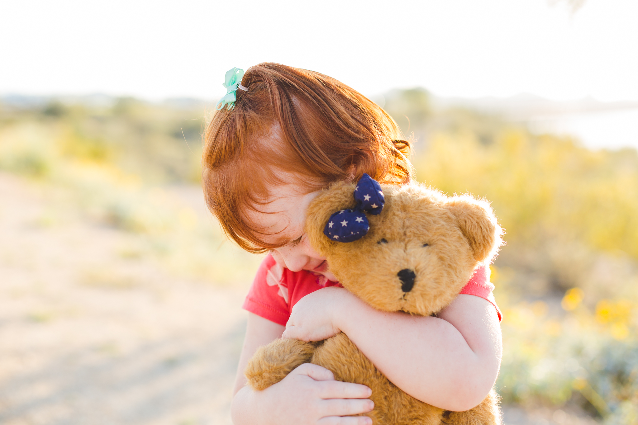 phoenix family photographer adorable girl hugging her teddy bear
