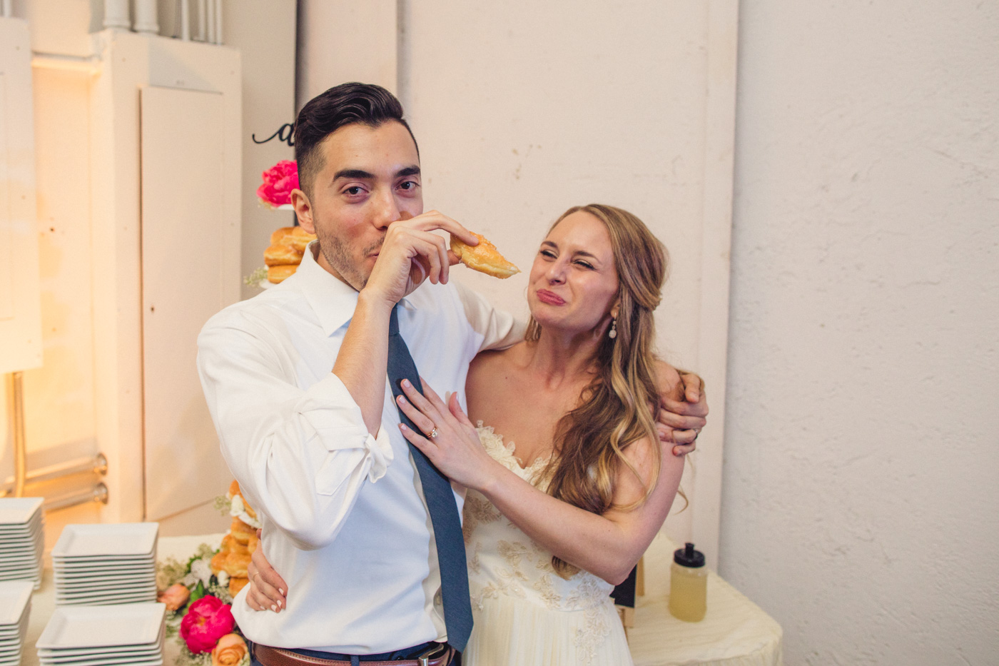 bride-and-groom-eating-donut-cake