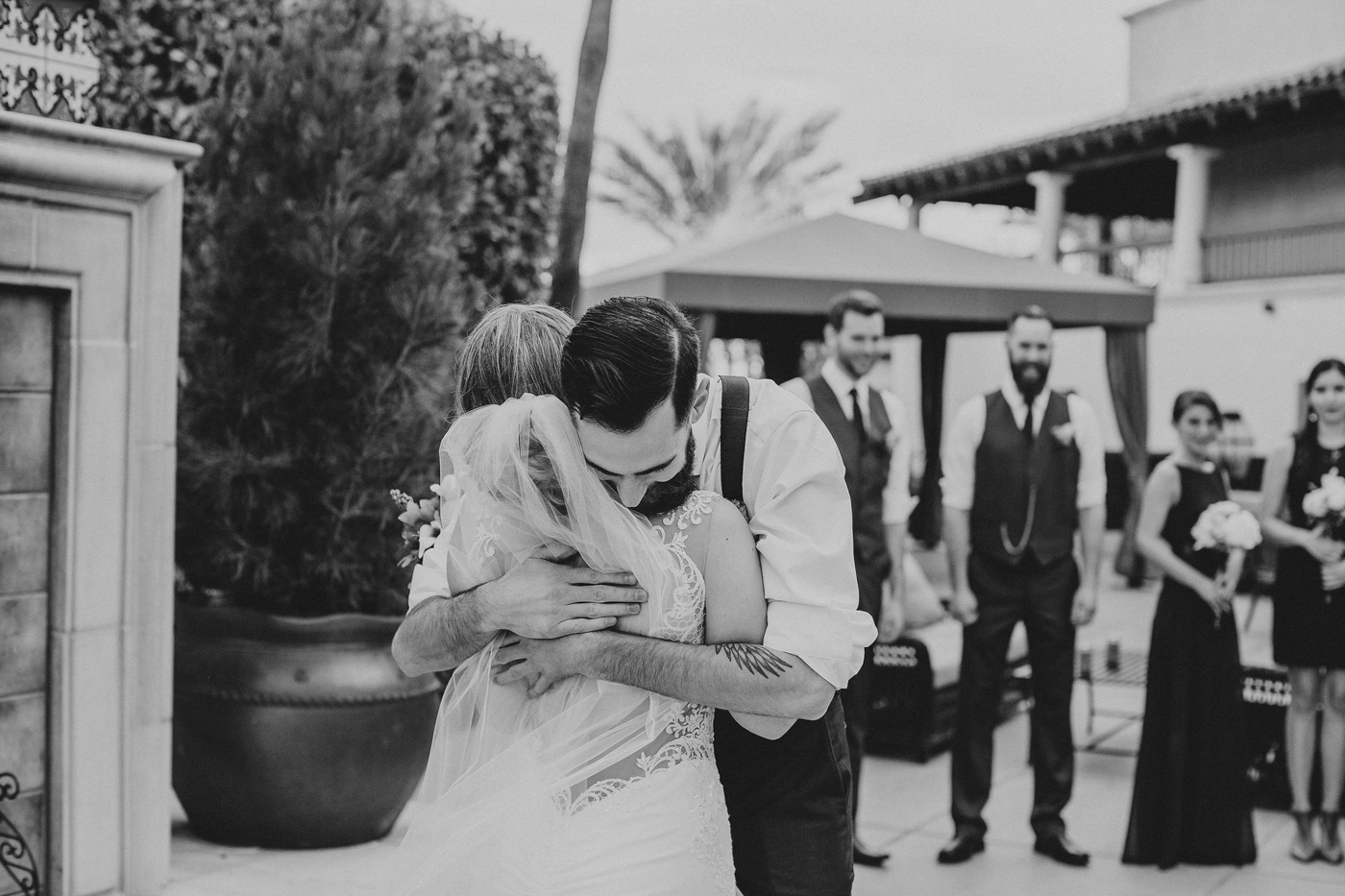 black-and-white-groom-hugs-bride
