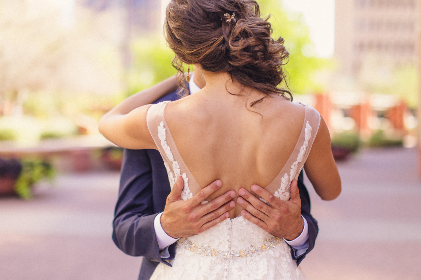groom-puts-arms-around-bride