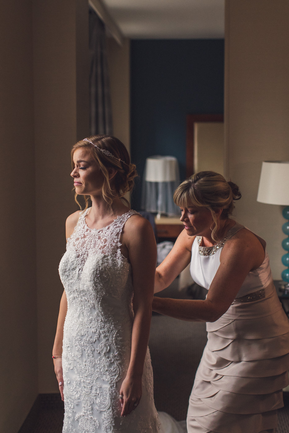 mother-getting-daughter-into-wedding-dress
