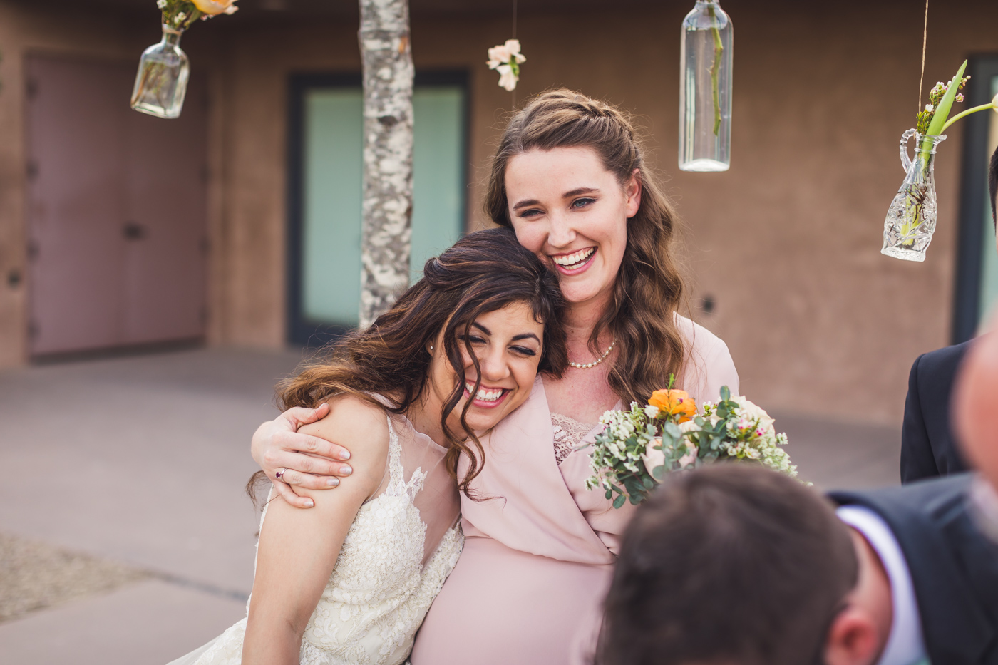 bride-and-bridesmaid-happy-embrace