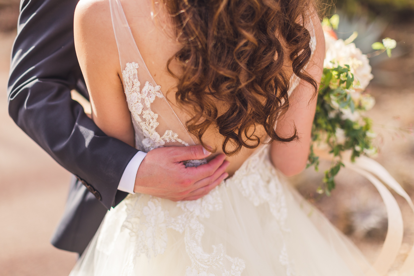 groom-holding-bride-detail