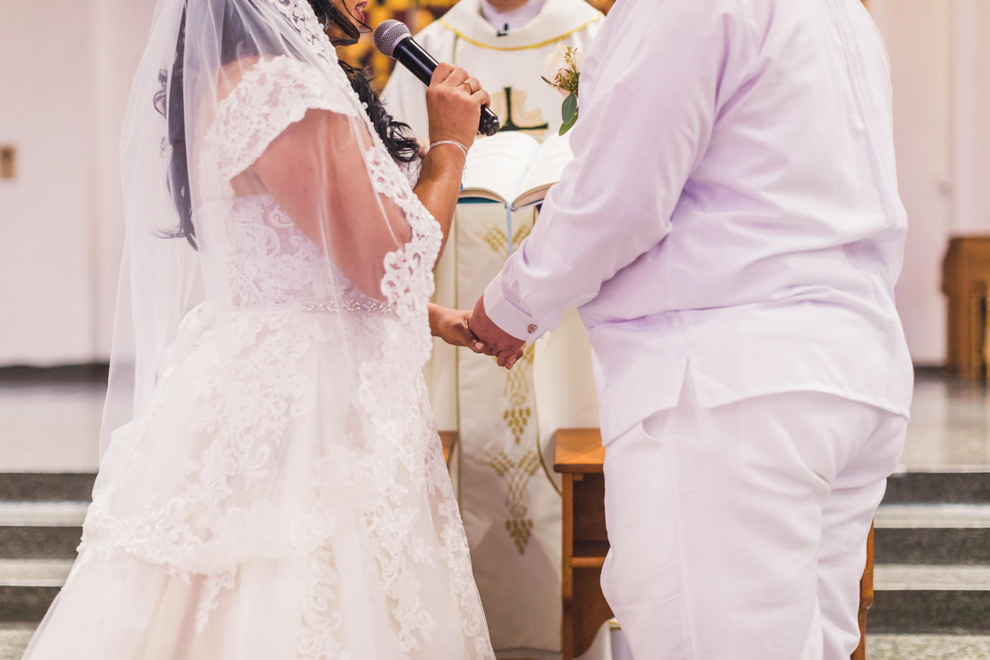 bride-and-groom-hold-hands-at-ceremony