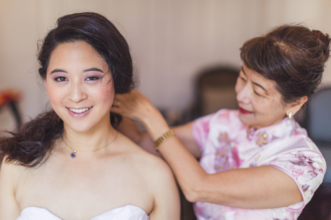 sf-bride-getting-necklace-put-on-by-mom