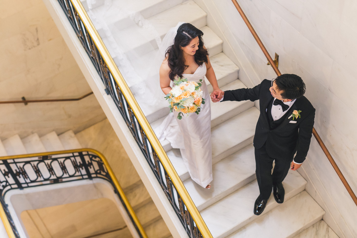 bride-and-groom-walking-down-stairs