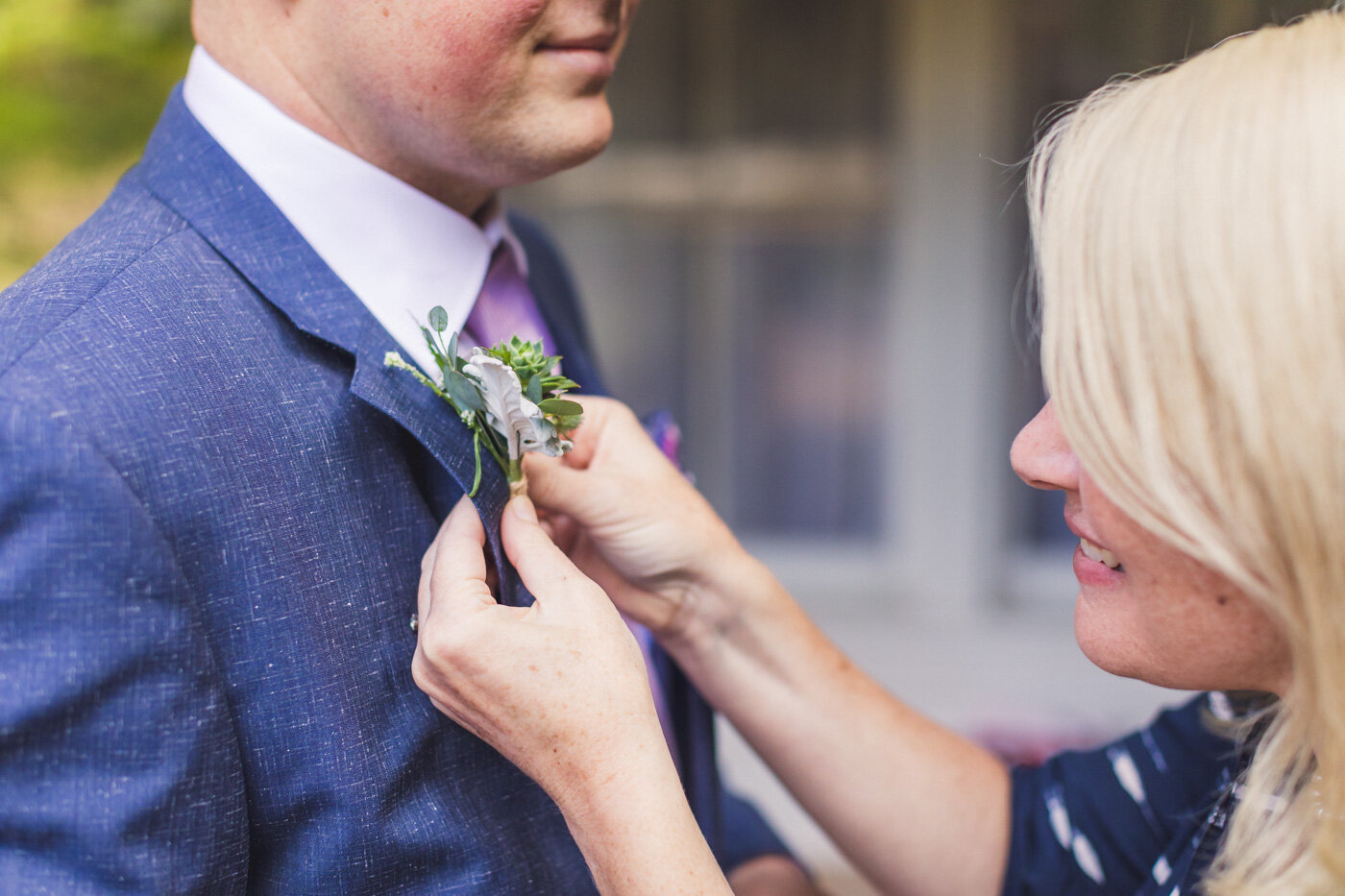 groom-getting-boutonniere-put-on