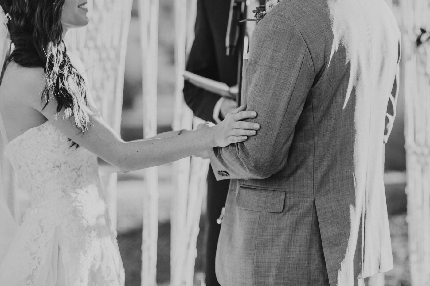 bride-puts-her-arm-on-groom-during-ceremony