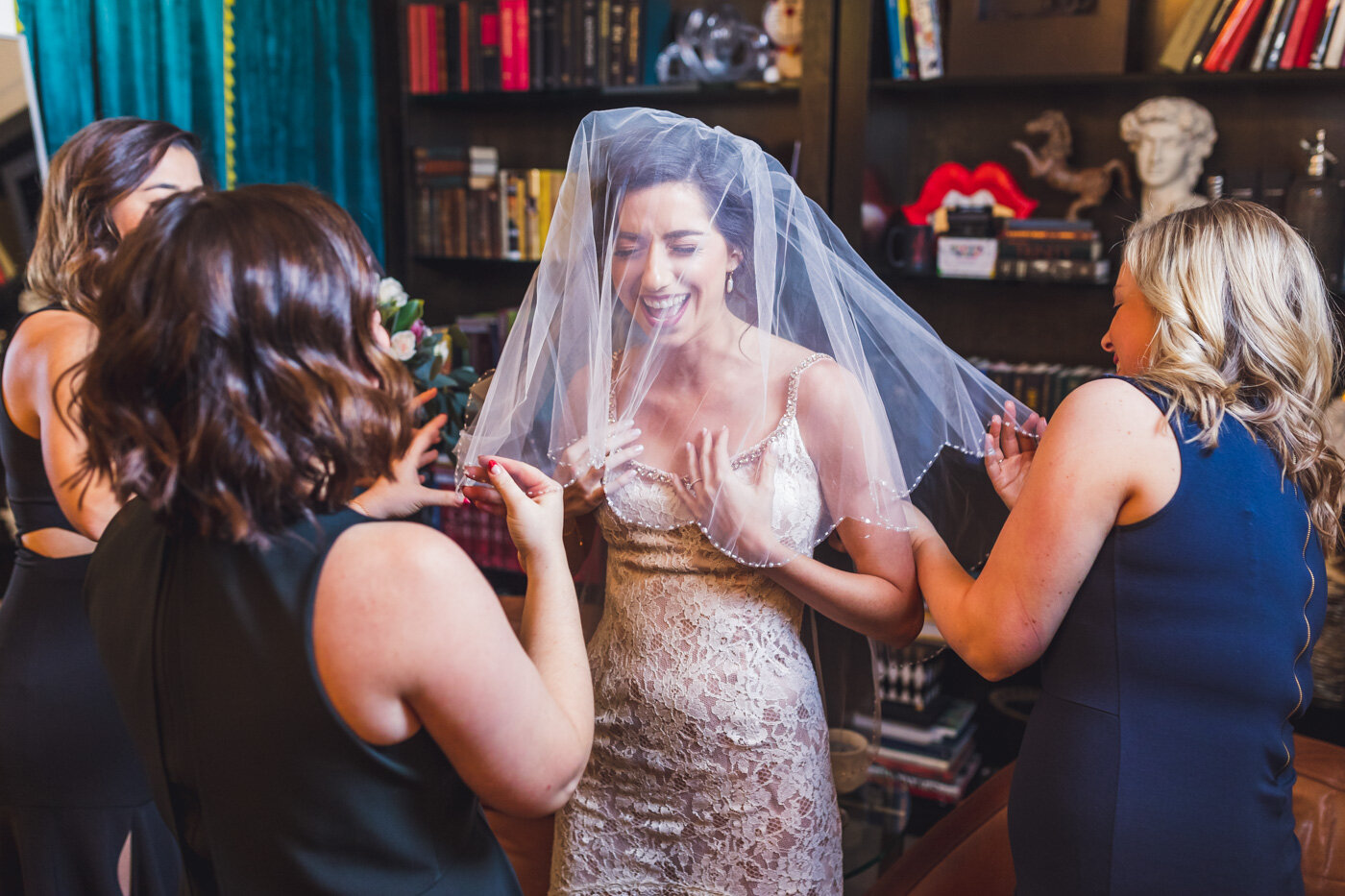 bride-puts-veil-on-laughing