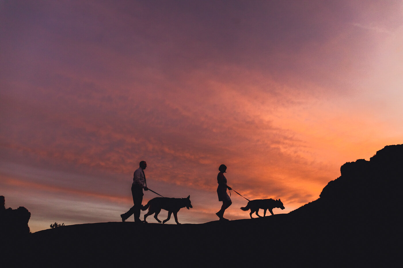 sunset-silhouette-couple-with-dogs