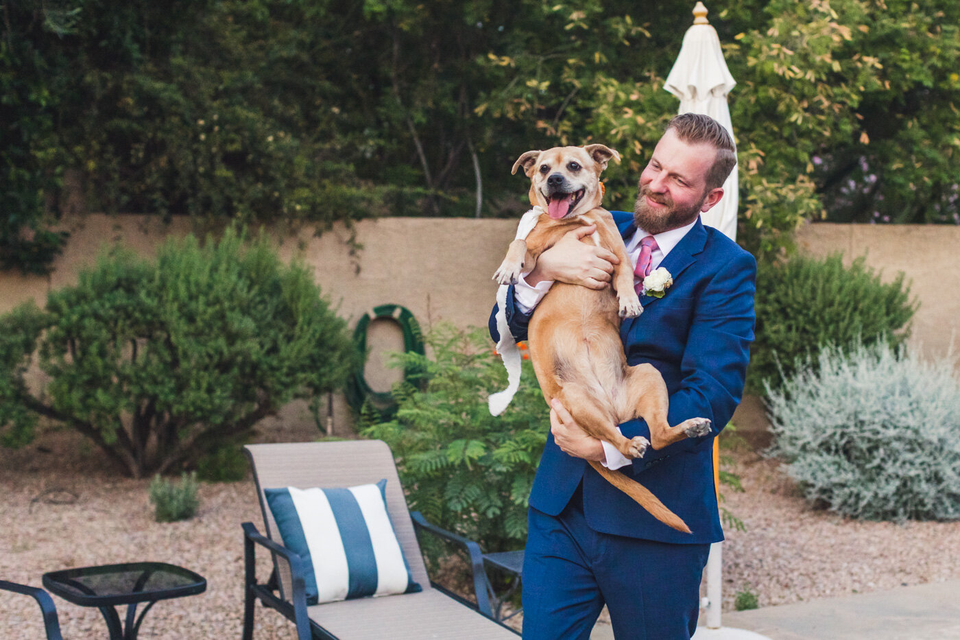 groom-carrying-dog-ring-bearer