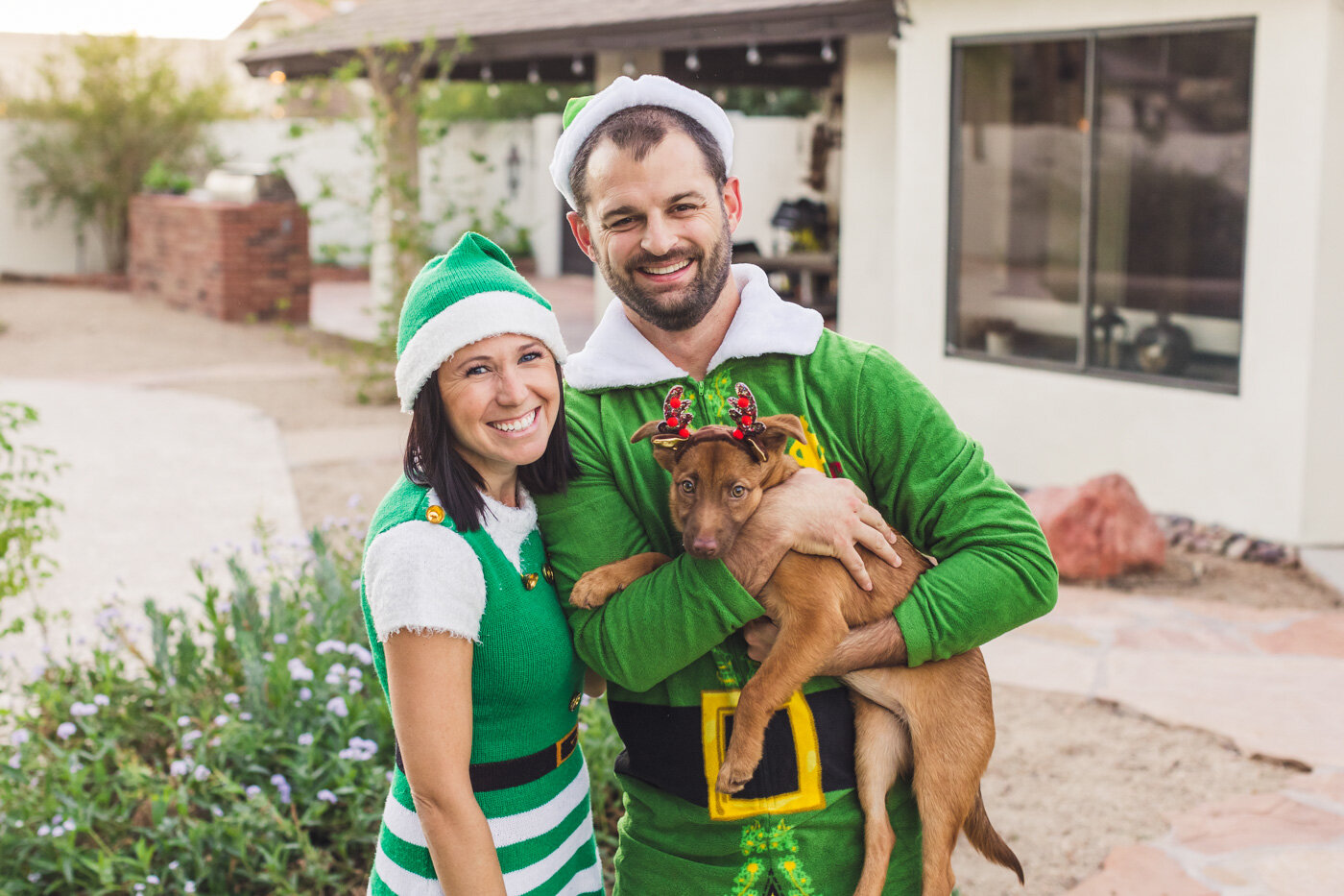 couple-with-dog-dressed-as-elves-and-reindeer