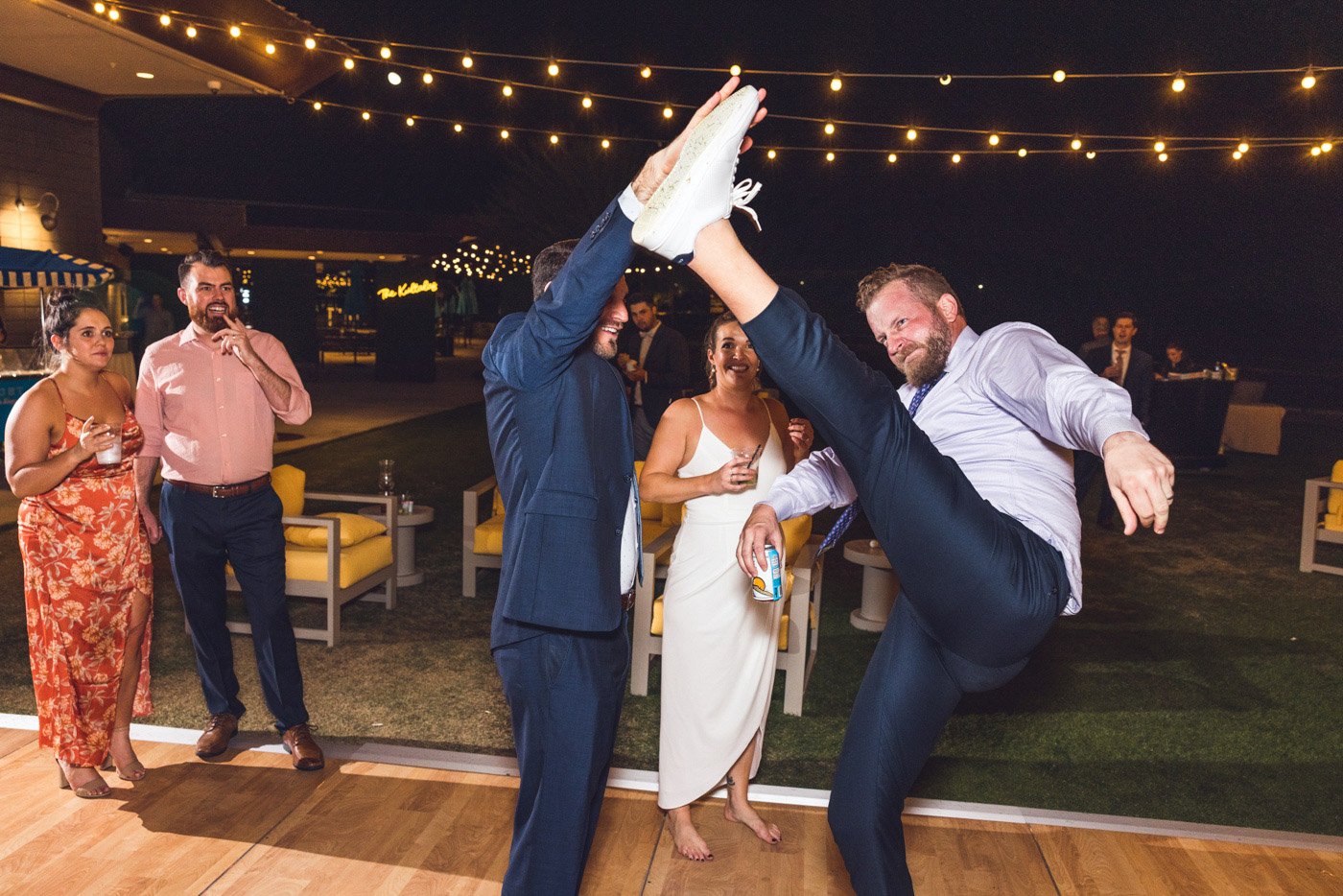 groom kicks wedding guest at reception for fun