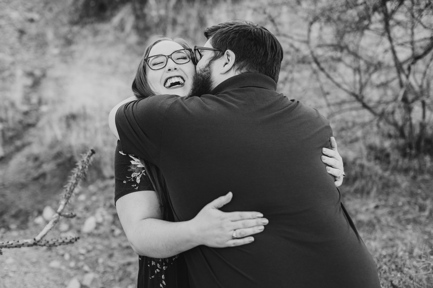 man surprises fiance with hug while she laughs