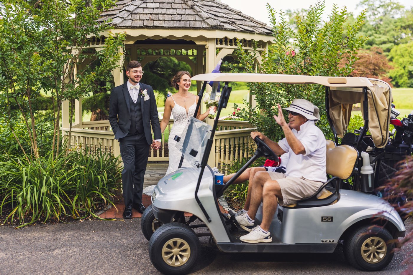 golf cart driving by bride and groom as they watch