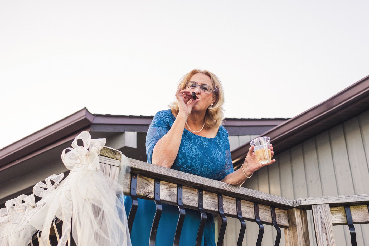 mother of the bride smokes a cigar after ceremony