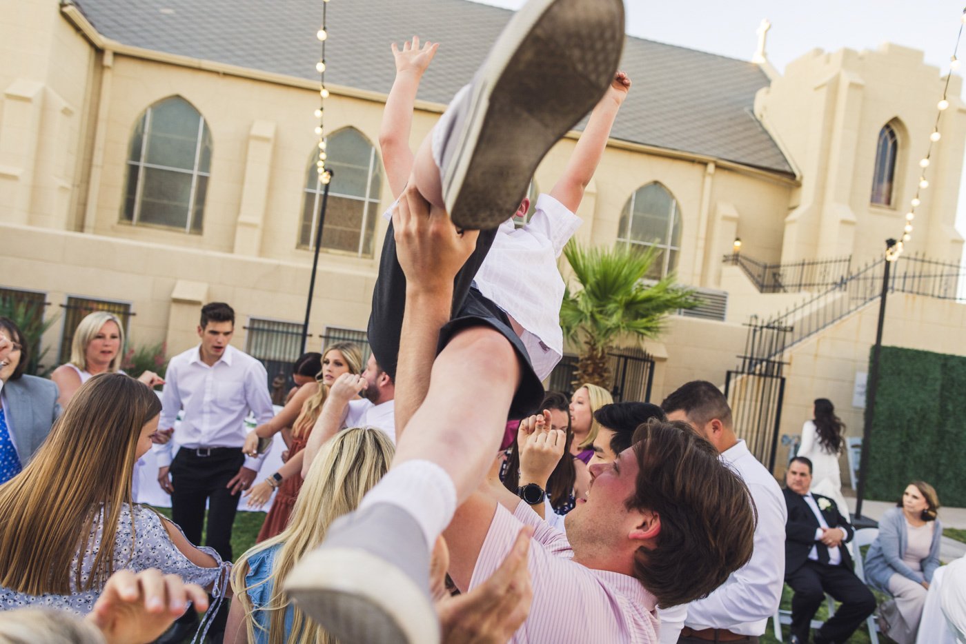 kid being tossed in air during wedding reception