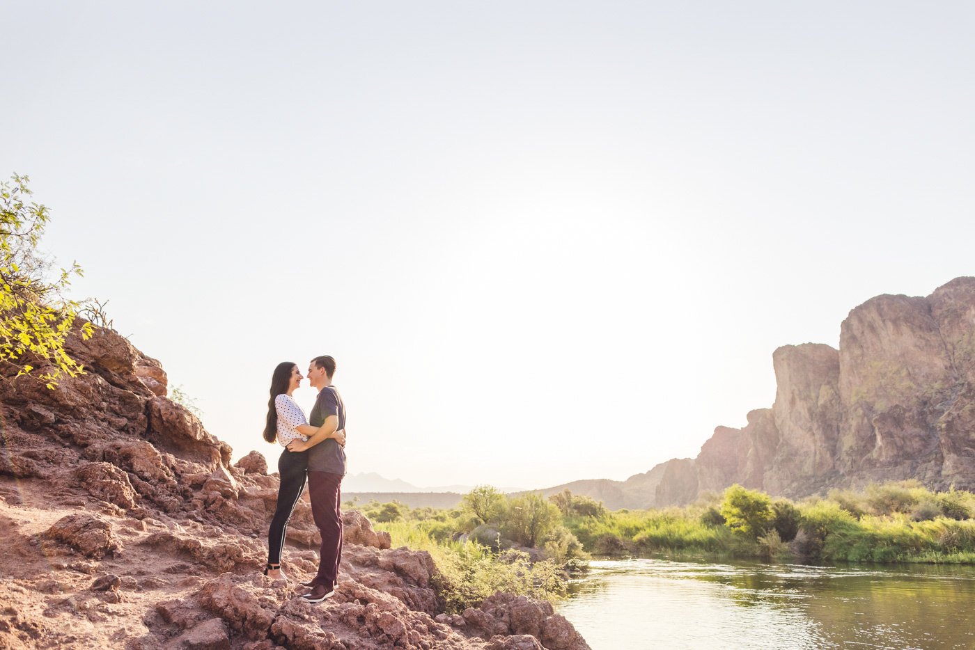 couple standing on rocks near salt river water