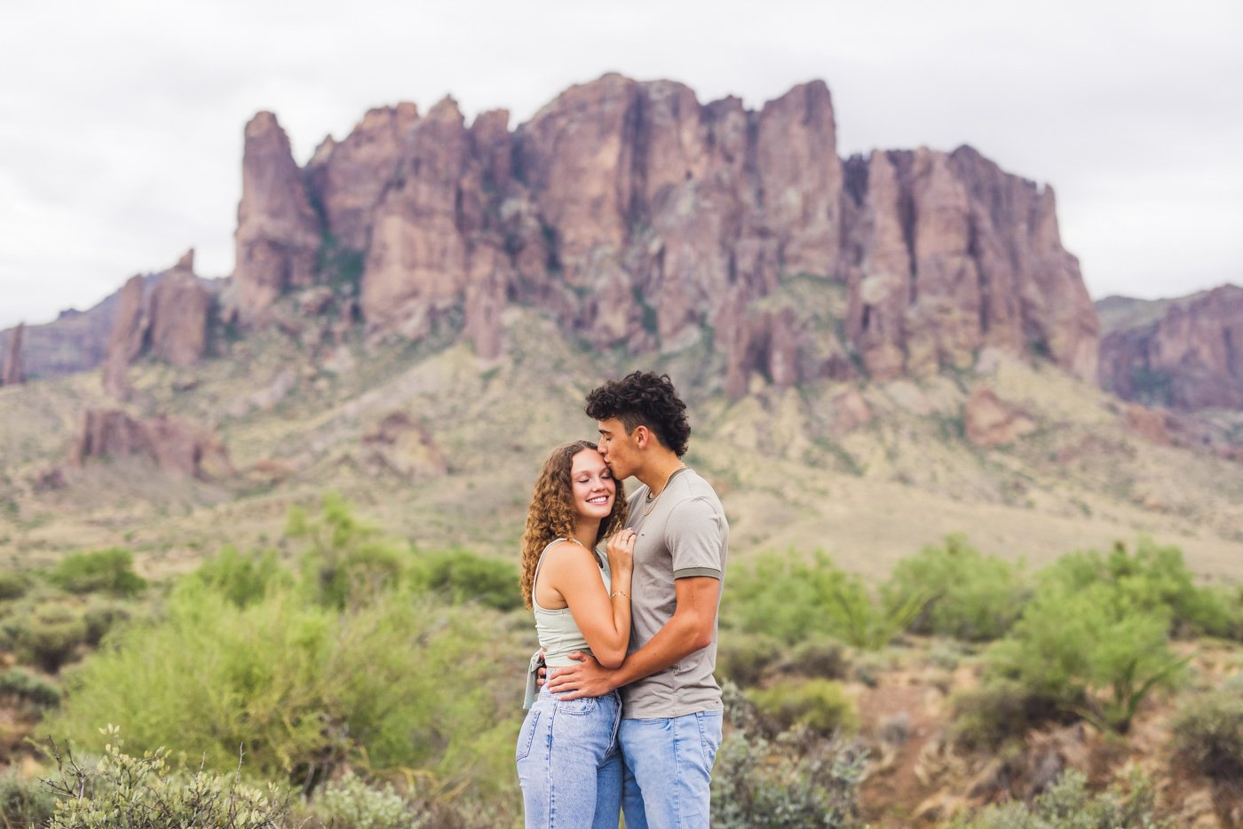 man kisses woman on forehead at superstition mountais