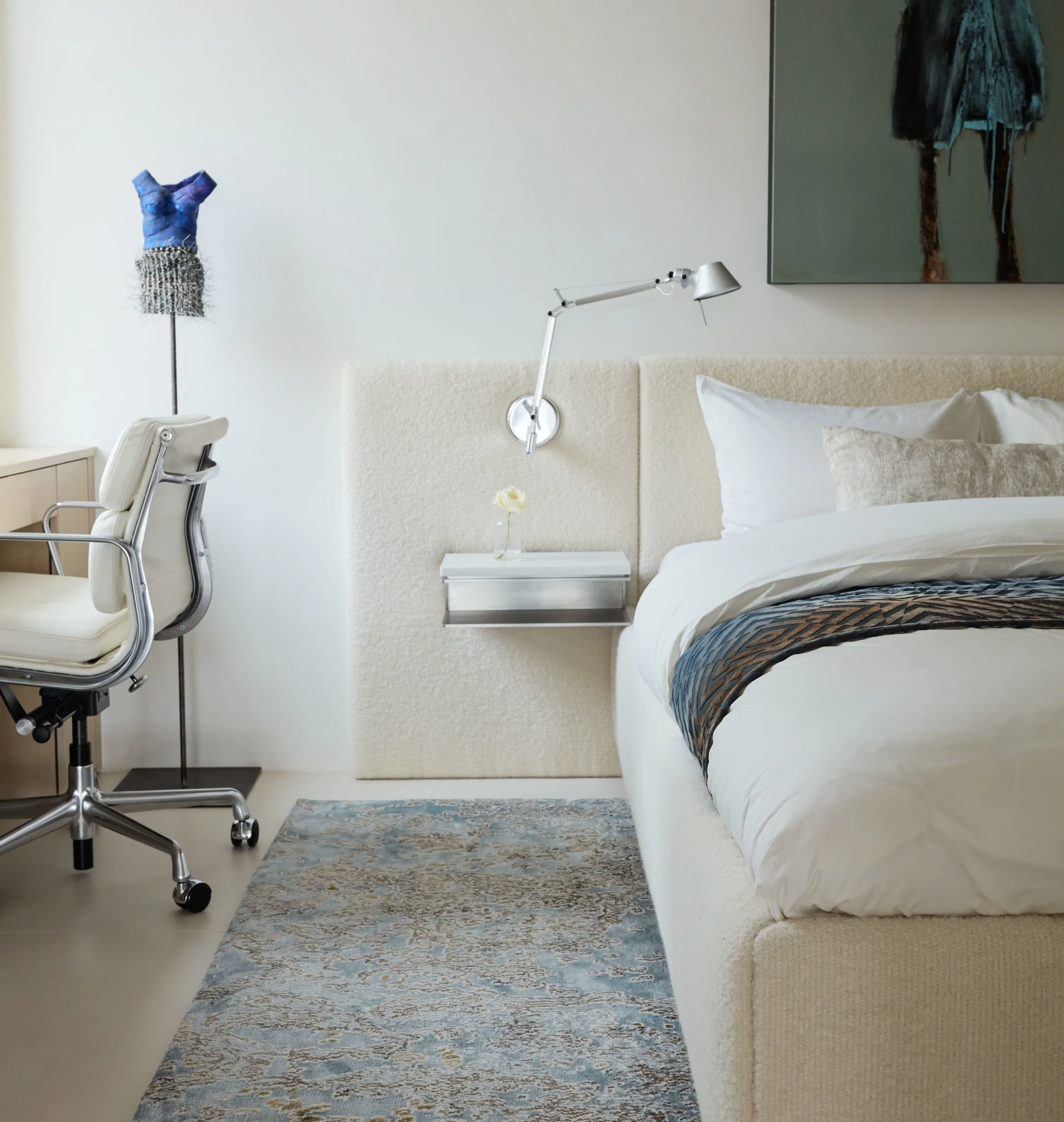 The master bedroom features a custom-made bed upholstered in Rosemary Hallgarten boucle fabric. The dress sculpture is by Jane Burton.