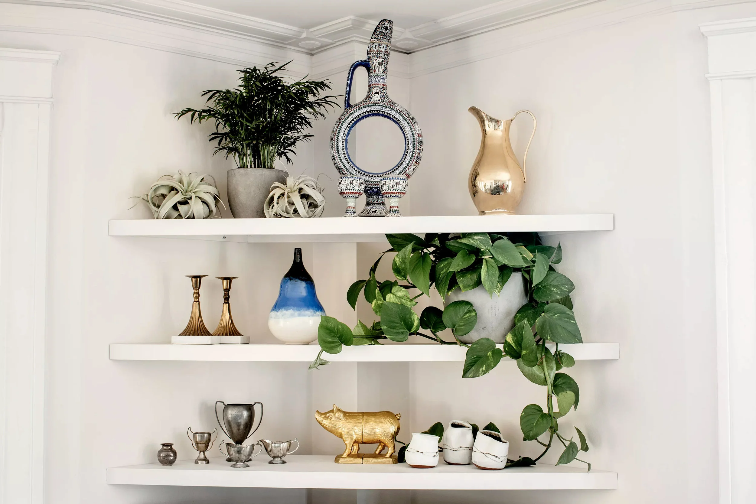 Alicia designed and installed a set of corner shelves that serve as a display area.