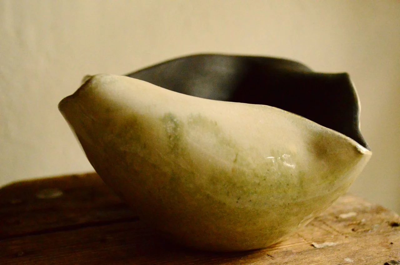 Stoneware bowl, thrown and altered, exterior glazed and interior raw black. 