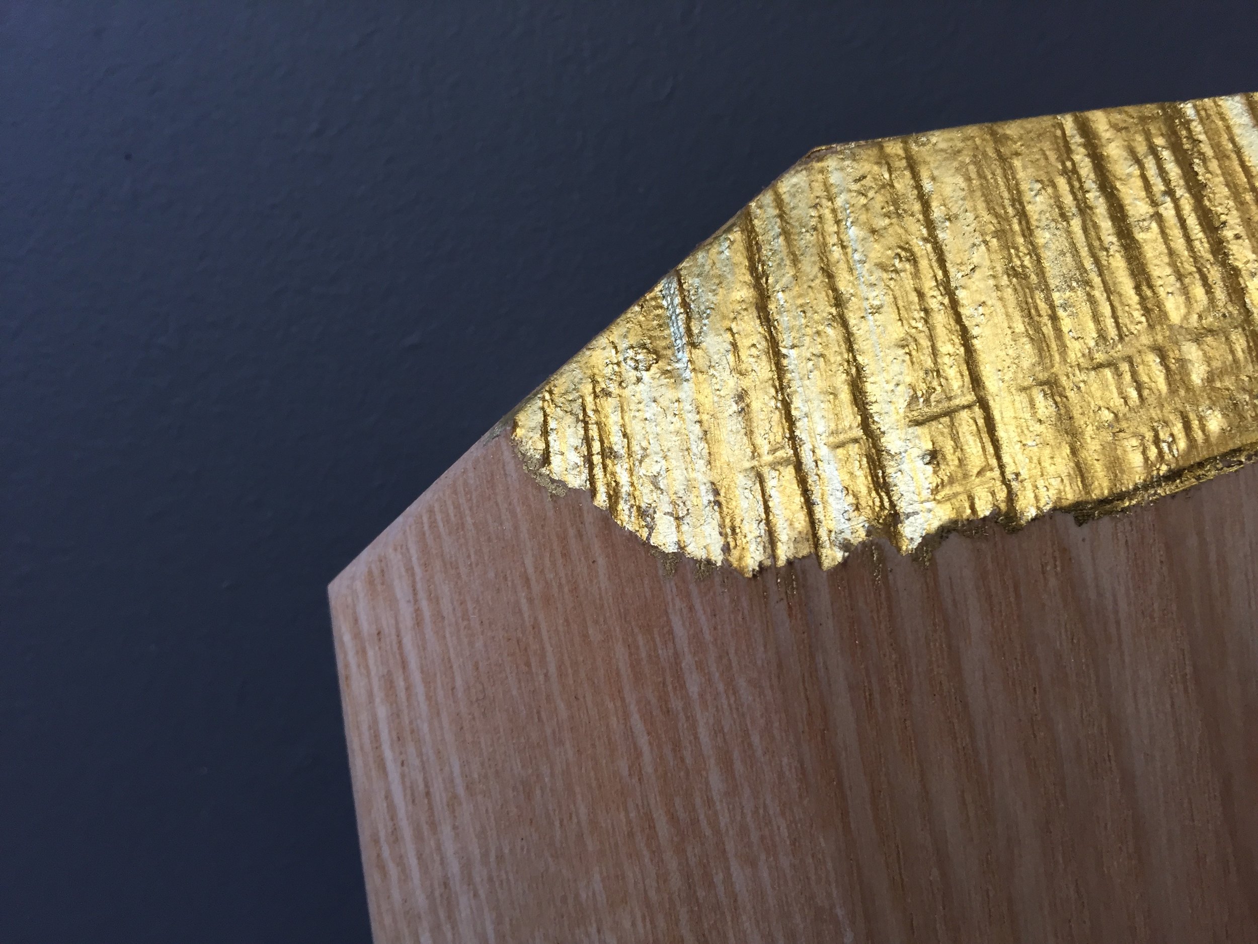  revealing a layer of 22 carat gold leaf on crafted clothes hangers