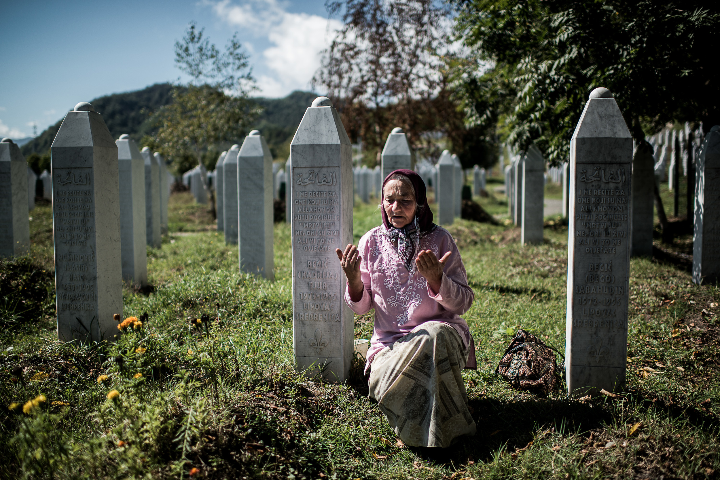 Mourner in a cementery for the victims of the massacre of Srebrenica in Bosnia and Herzegovina