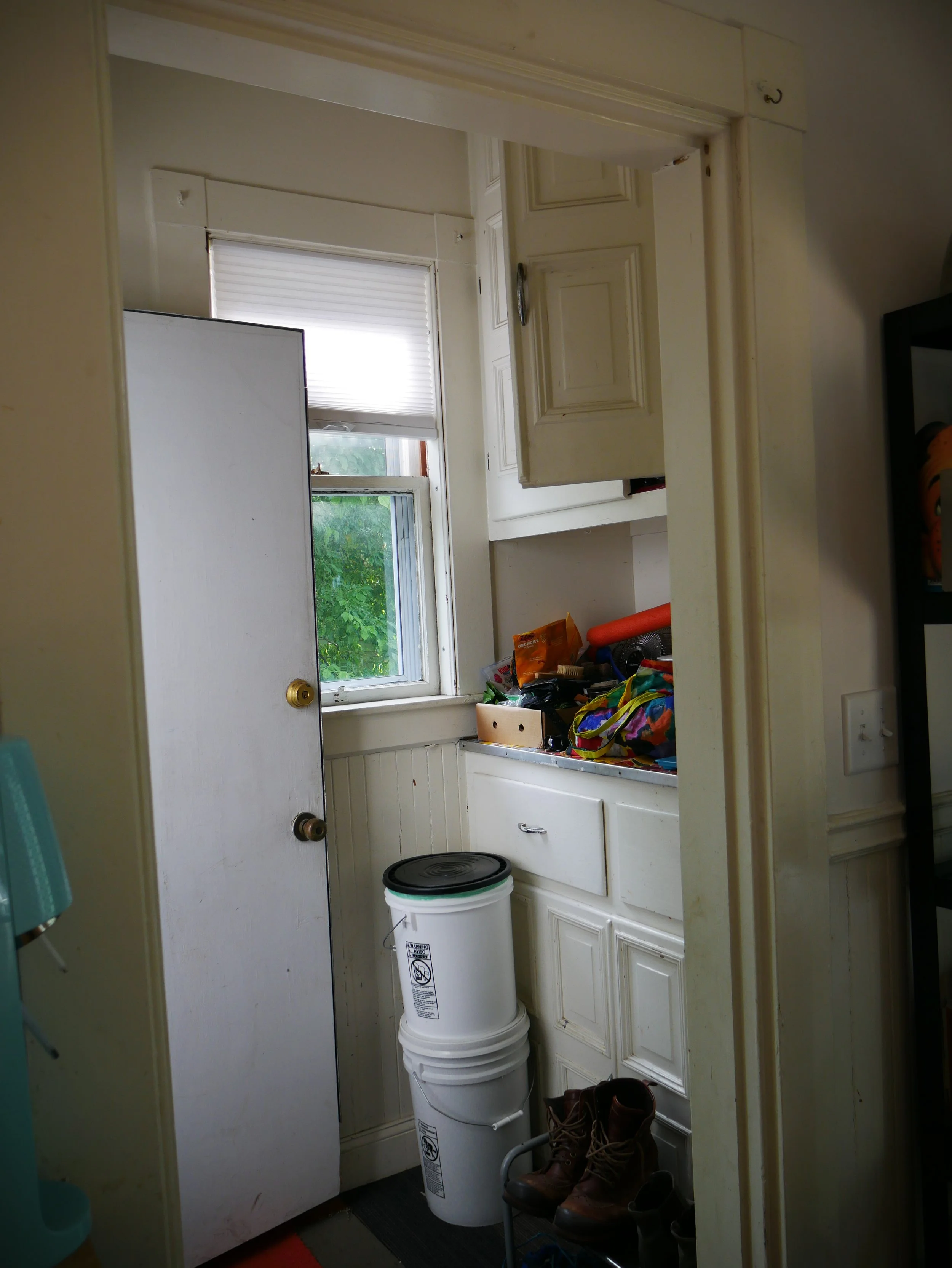 Before shots! This "mudroom" was elminated for a more streamlined access to the back porch and yard.