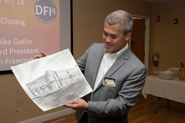 Downtown Hero Brian Li admires a live sketch of his property, the Bullard Building, by artist Jason Cheeseman-Meyer