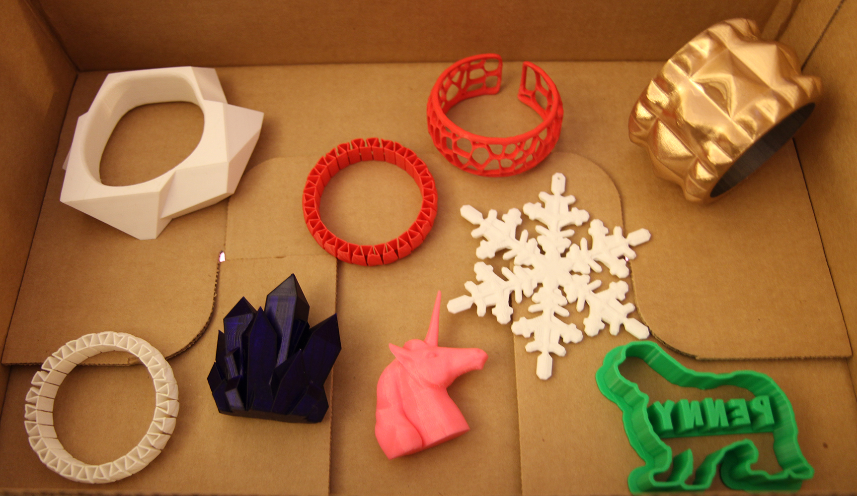  Assorted winter holiday gifts, 3D printed using a MakerBot Replicator 2 in PLA. Featuring custom bracelet and cookie cutter designs by Danny Bailey. 