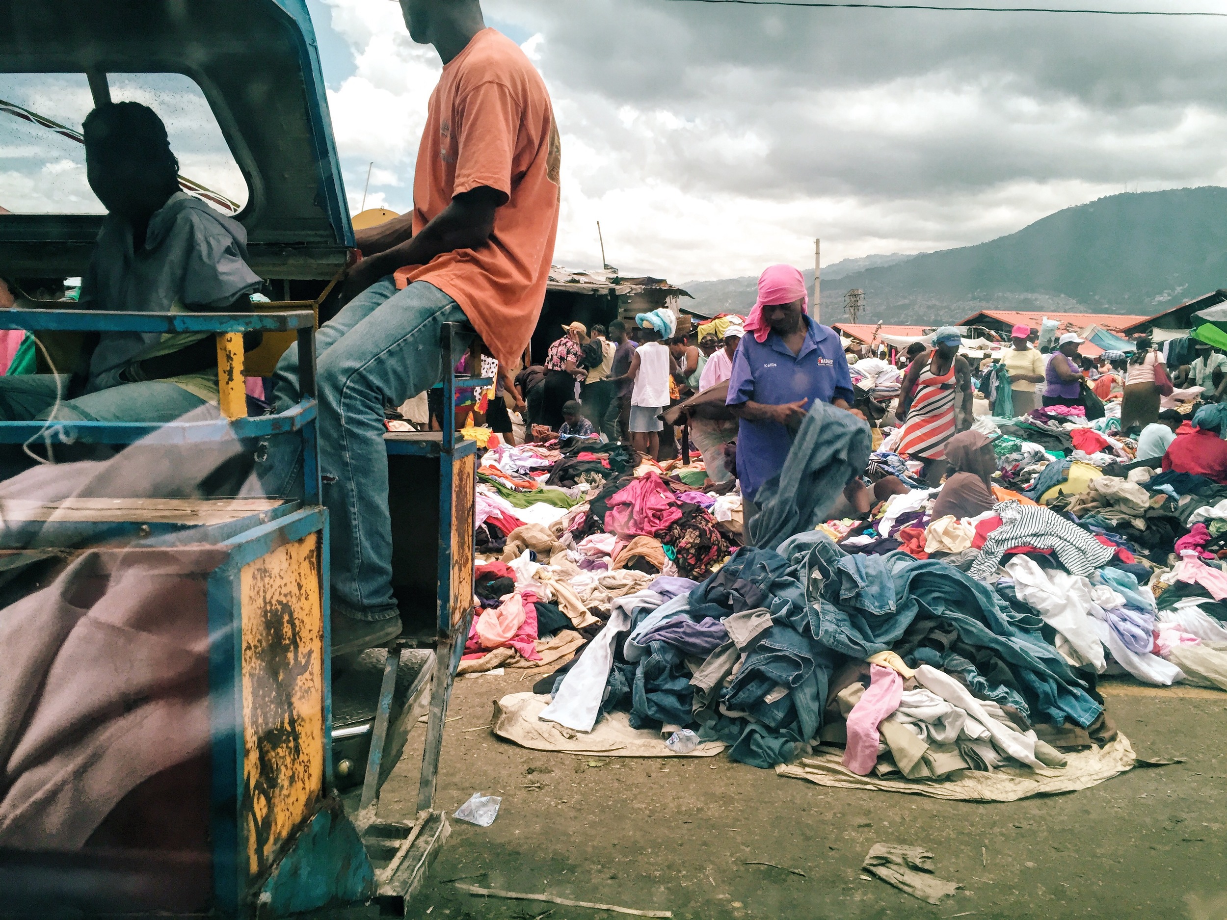 A local market in downtown Port-au-Prince, where a man sifts through a pile of secondhand clothing.
