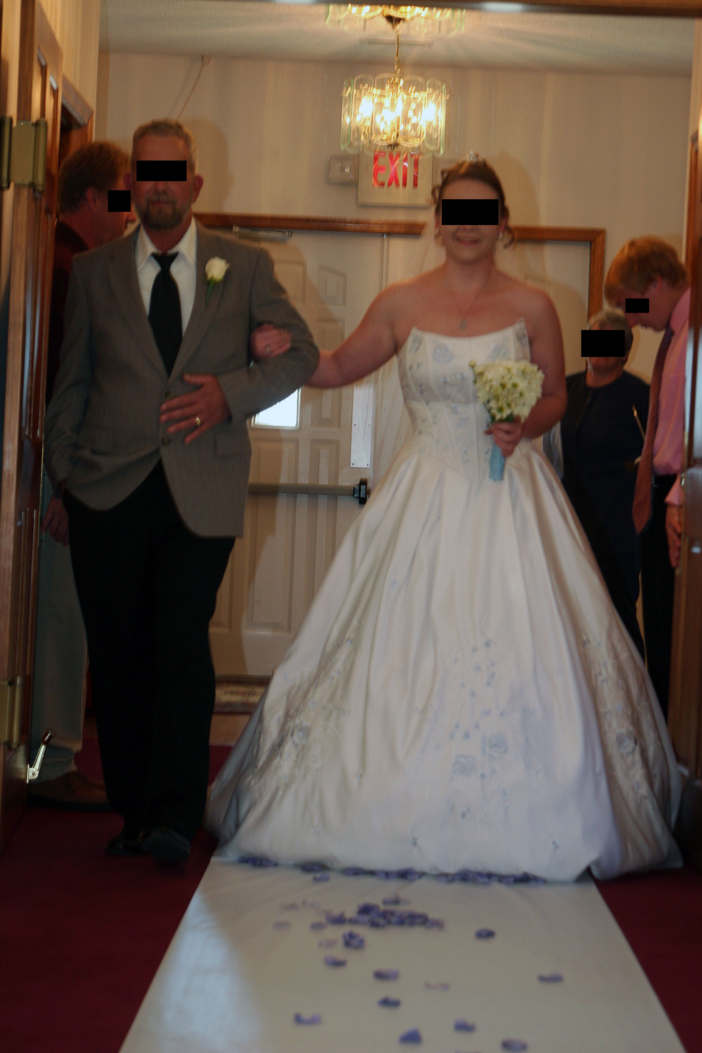 Here comes the bride! Unbeknownst to her, the church was located over a major fault line, because clearly an earthquake is in progress to explain why the images is out of focus and tilted, right? The "exit" sign may or may not be allegorical. BTW, another photographer - in addition to focus and proper exposure - may have photoshopped the sign out, or may even have instructed the people to close the doors after she enters and eliminate both the sign and the light.