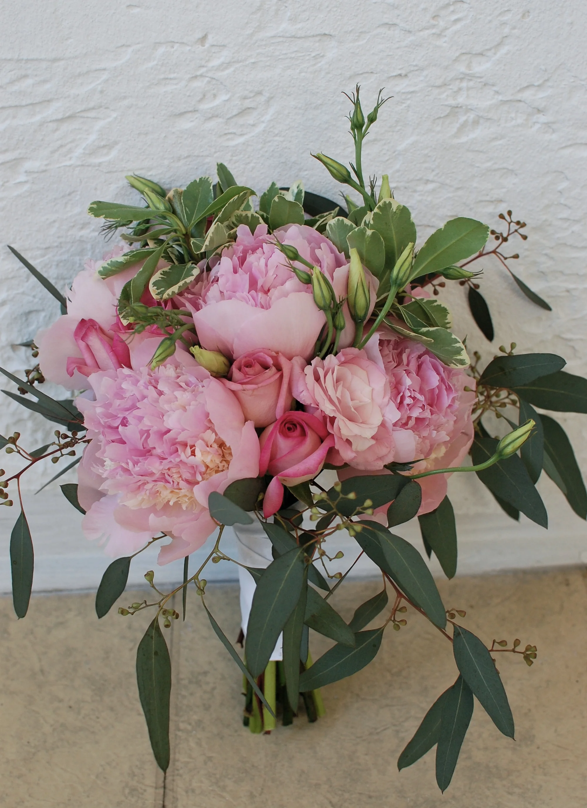 Peonies, roses, lisianthus, and seeded eucalyptus
