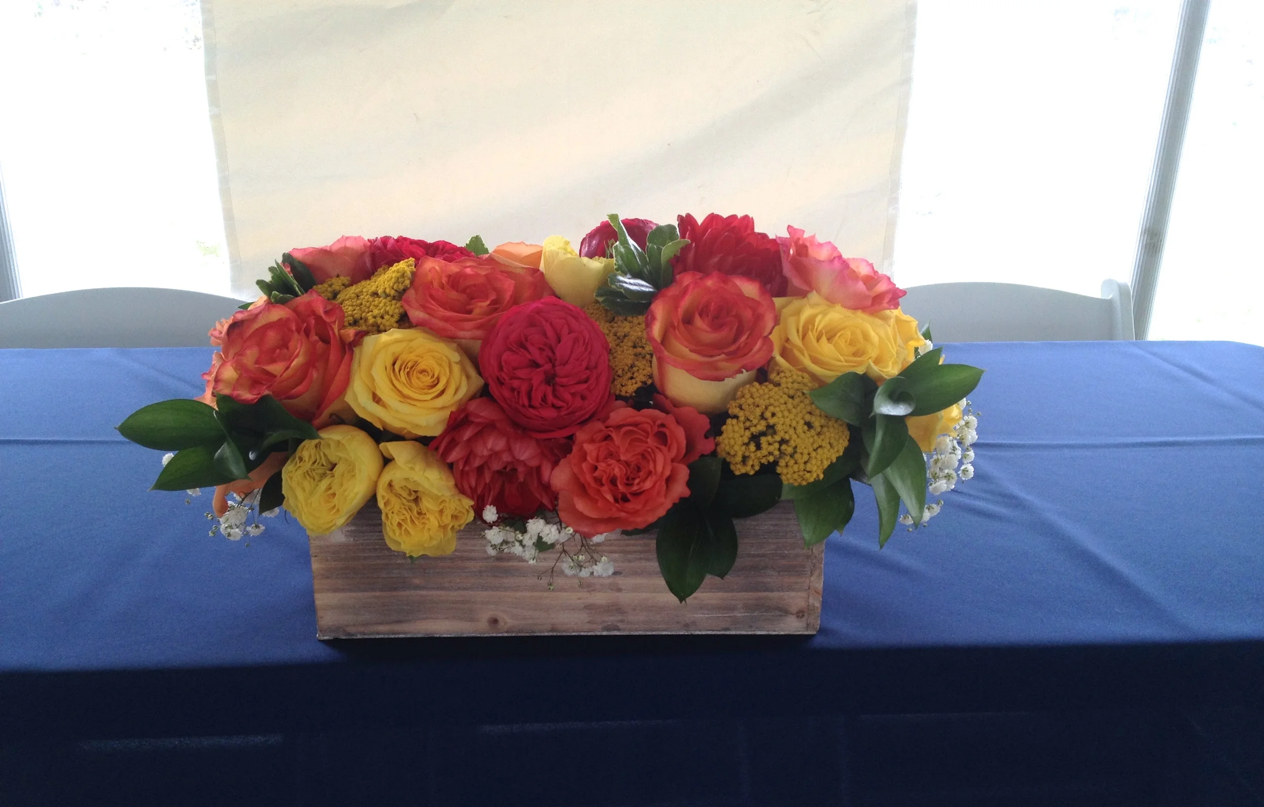 Head table flowers in whitewash wood box. 