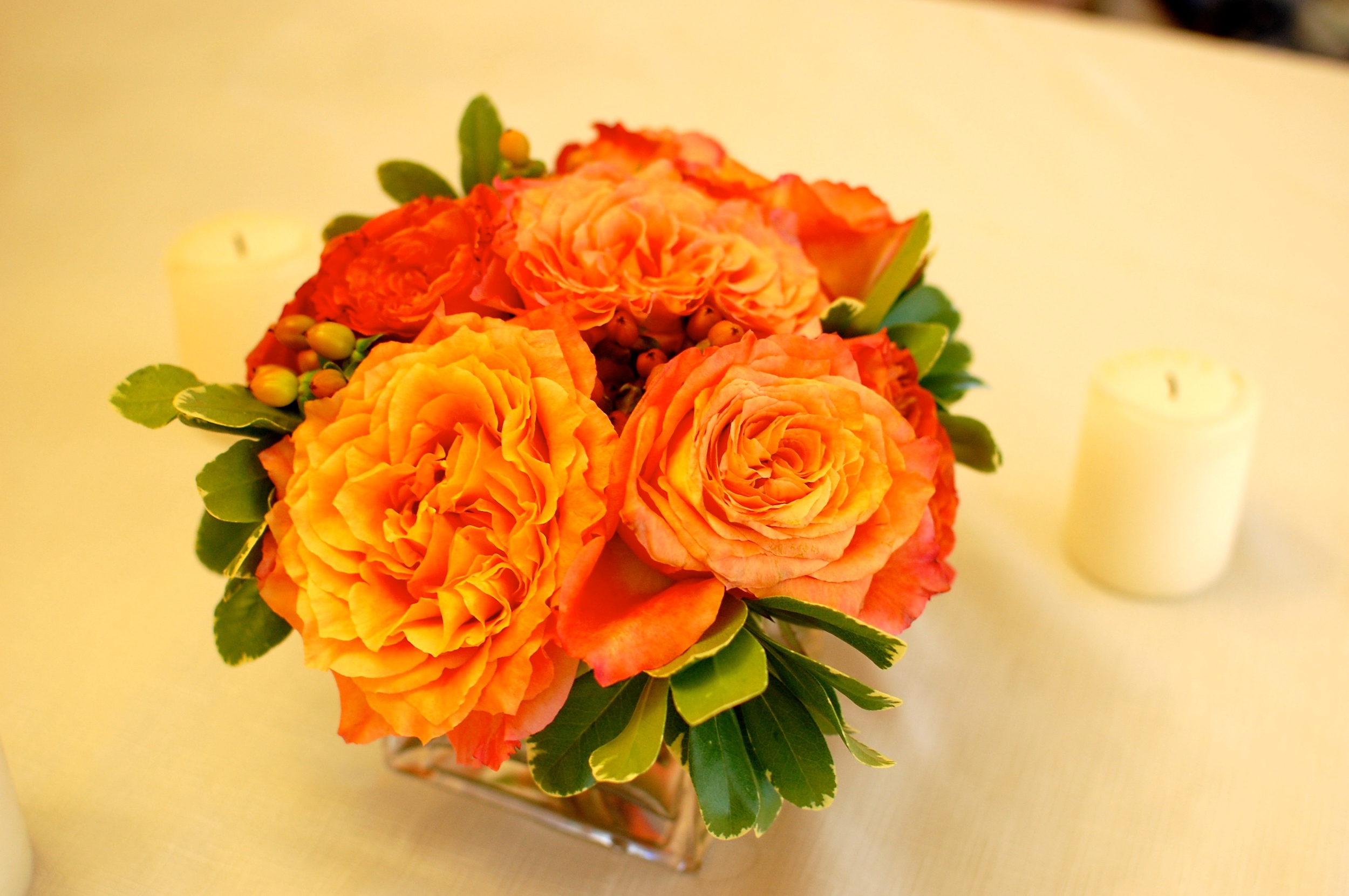 A beautiful fall arrangement of garden roses, hypericum berries and greenery.